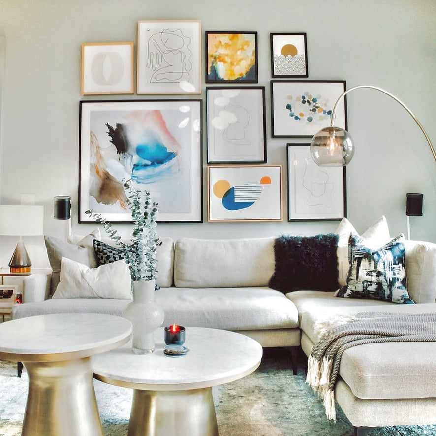 colorful gallery wall in neutral living room white couch