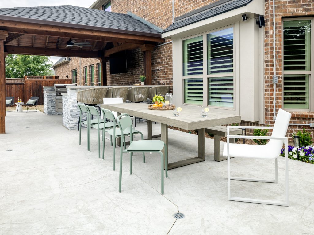 neutral patio dining set with green chairs