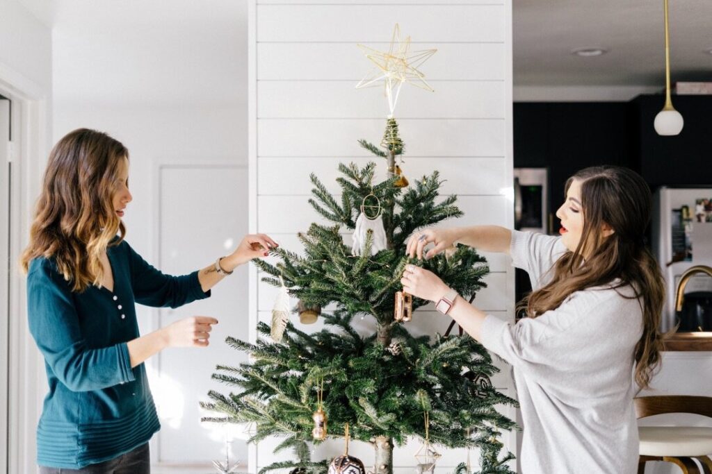 rebekah nicole interiors decorating a christmas tree in a white room